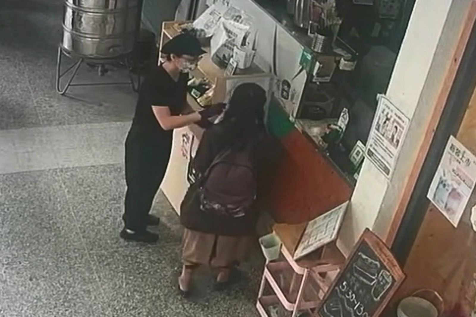 婦人強行拿走早餐店餐檯上的三明治，店員見狀趕緊上前制止。畫面翻攝threads u_and_m97