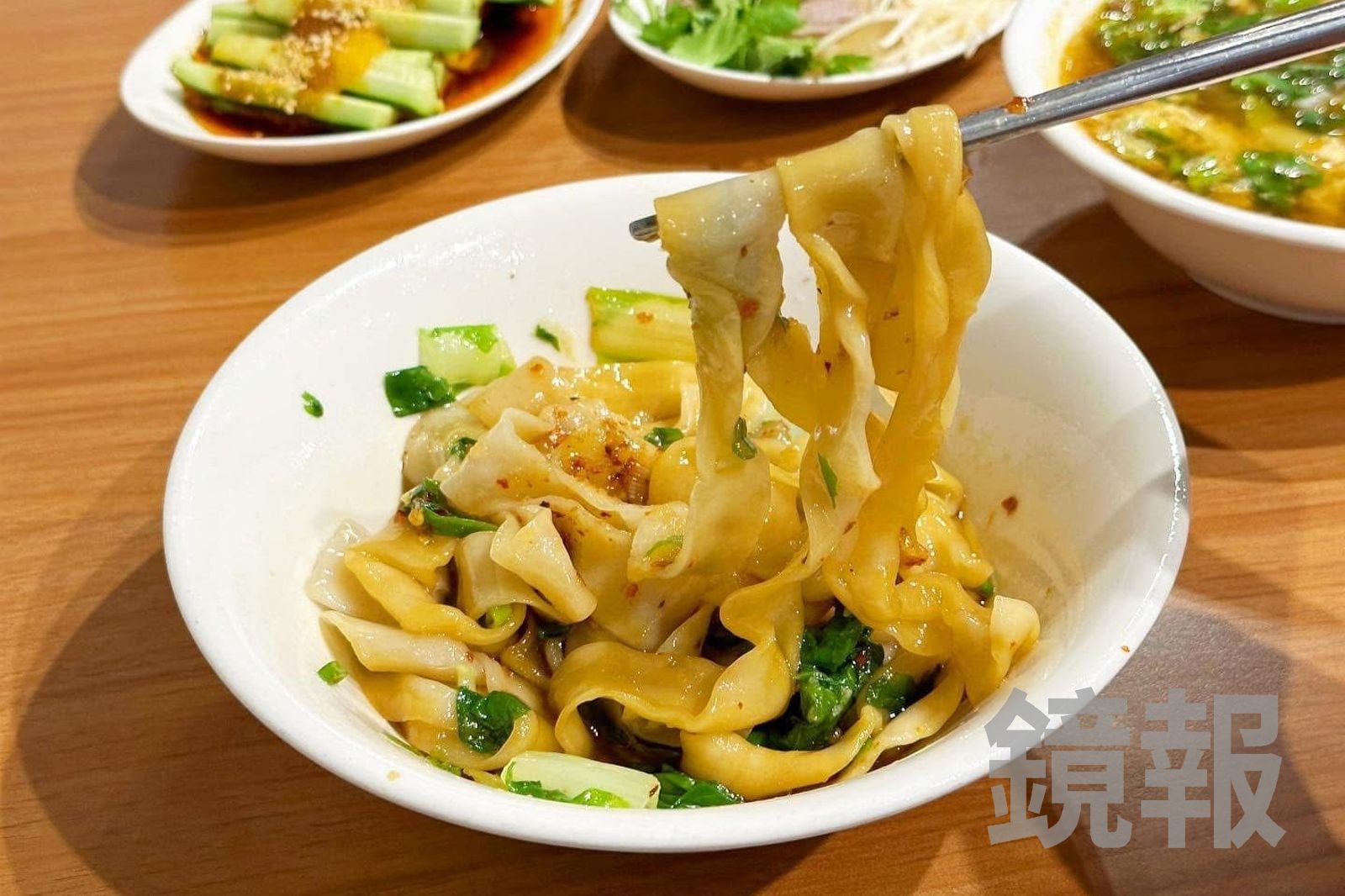 「油潑寬帶麵」麵條滑Q不糊爛，辣度溫和、醬香明顯。（85元／碗）