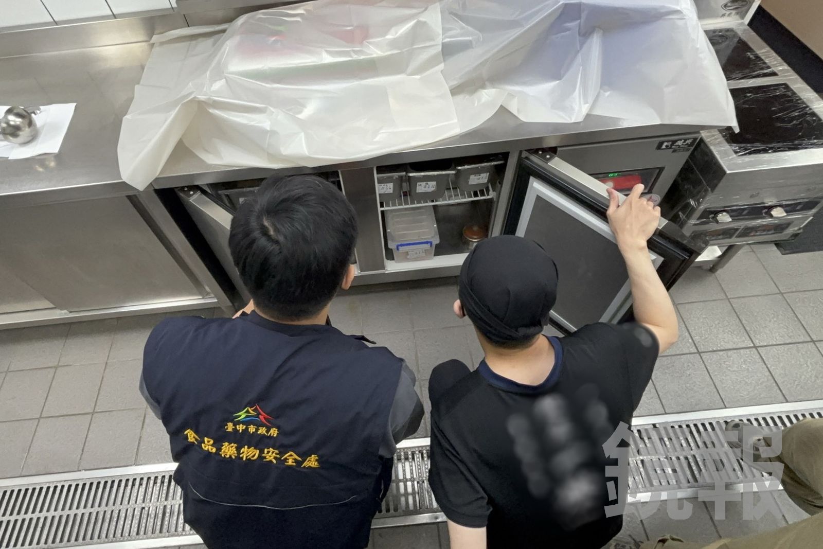 台中市食安處派員到拉麵店進行稽查，向店員確認冰箱保存食物的狀況。台中市食安處提供