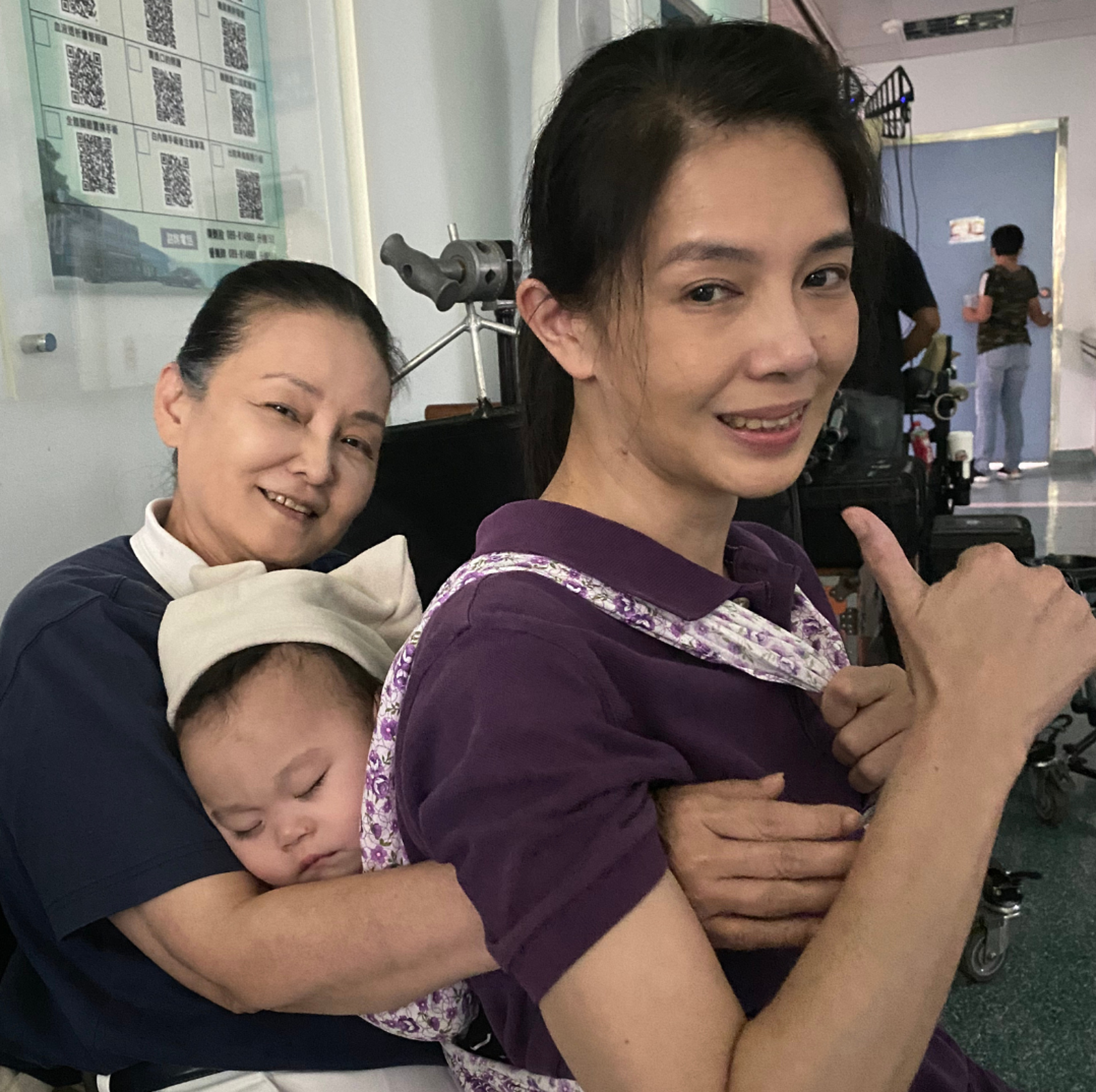 林美貞（右）在《生命的麥田》揹嬰，王淑娟（左）幫忙當靠背。大愛電視提供