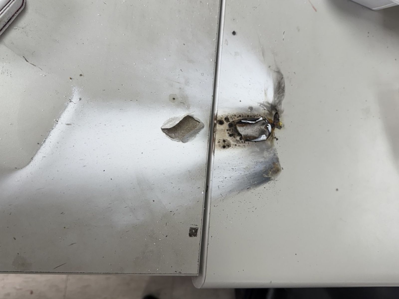 派出所辦公桌燒毀破洞。翻攝畫面