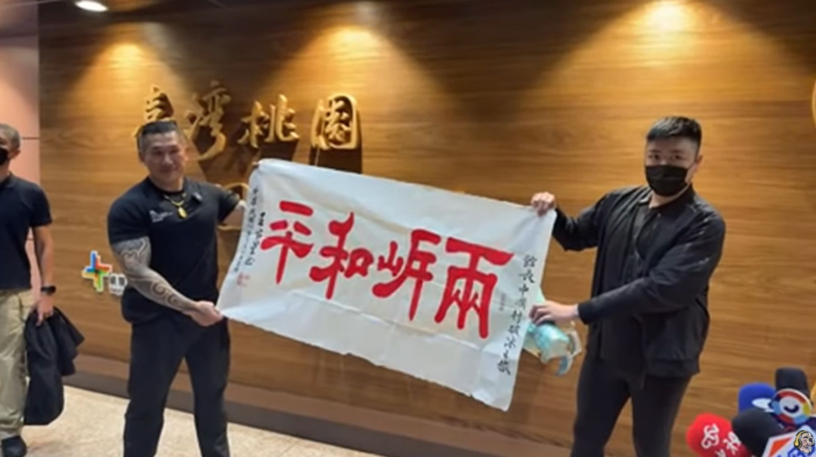 館長跟歷史哥舉起「兩岸和平」布條。圖/翻攝自館長惡名昭彰 YouTube