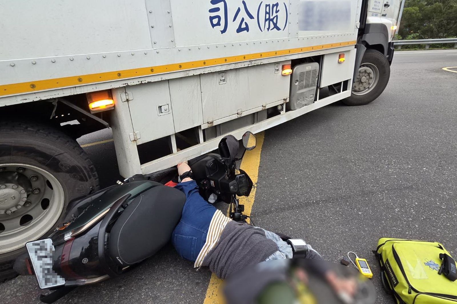 林姓機車女騎士連人帶車卡在車底，命懸一線。民眾提供